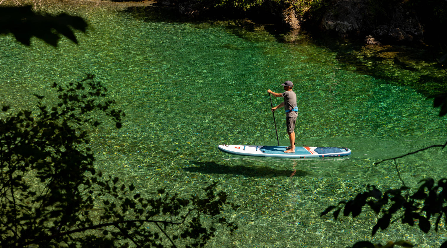 Paddleboard on clear green water